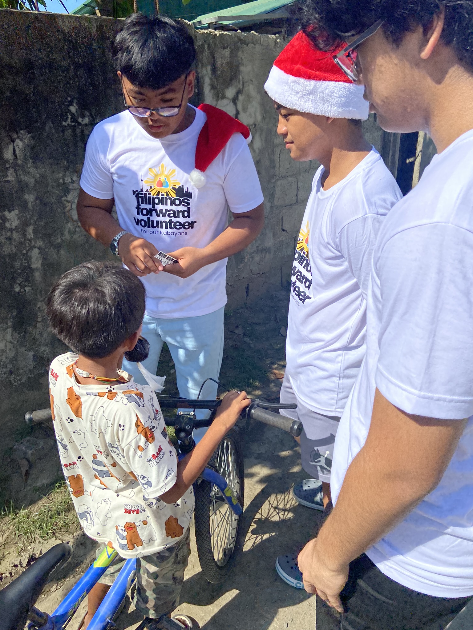 Children receiving hot meals at the 3rd Annual Christmas Feeding Project 2025 in Bauang, La Union